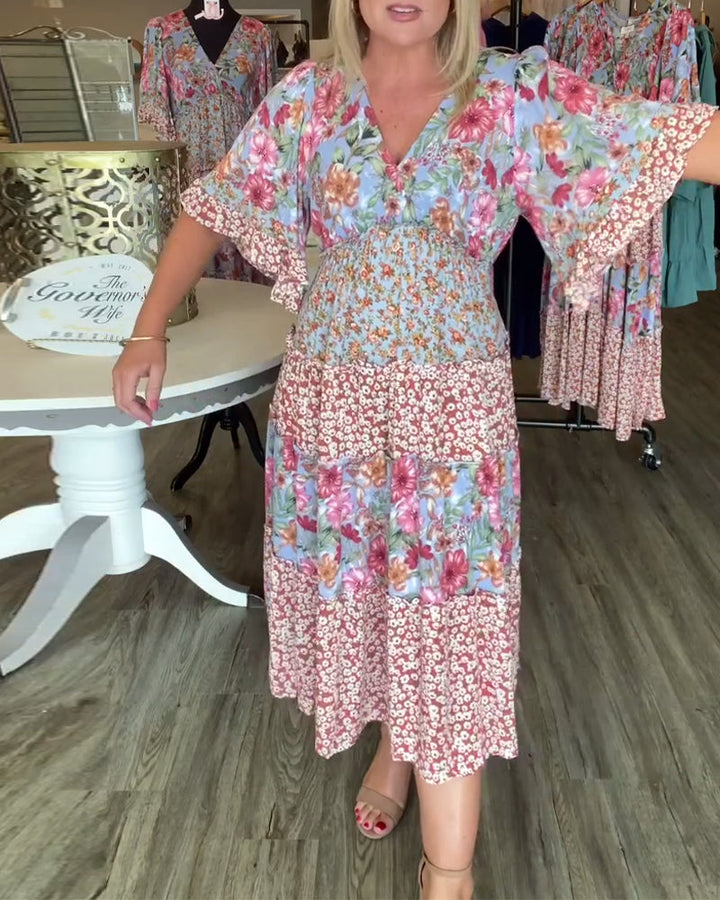 Bloemenjurk met V-hals en lotuszoom