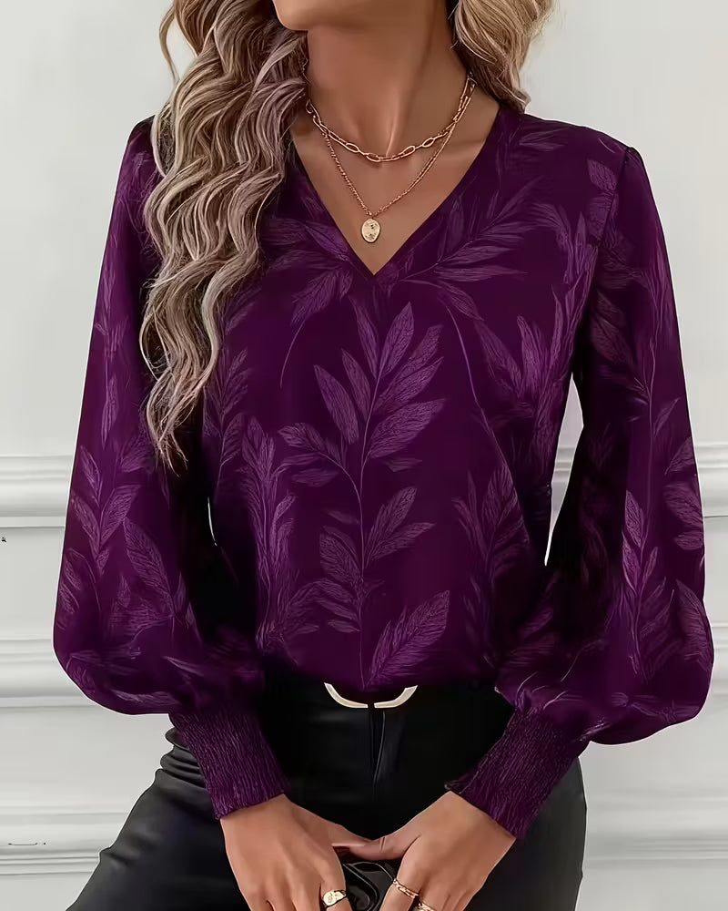 V-hals blouse met lange mouwen en bladmotief